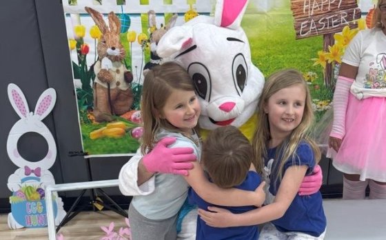 family hugging the easter bunny