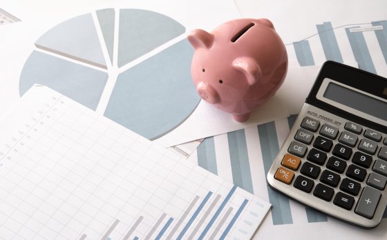 piggy bank, calculator and charts