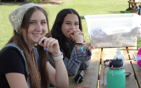 two teen girls sitting at a park table at Camp Glacier Lake