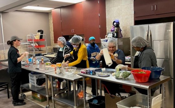 volunteers cooking at the Lily Cafe at the Maplewood Family YMCA