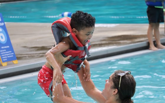 Kid playing in pool at Camp Arrowhead