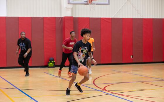 a photo of four teen boys playing basketball at the Maplewood Family YMCA