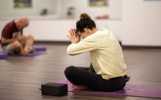 a yoga instructor at the ymca at innovation square leading a class