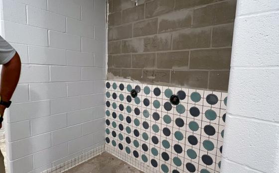 Construction progress of a shower in a locker room at the Sands Family YMCA