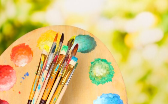 Paintbrushes and palette with nature background