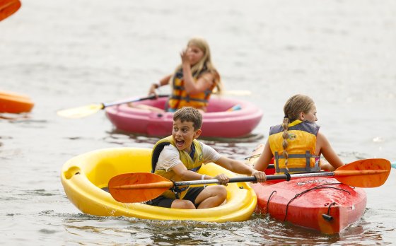 Campers having fun kayaking in the lake.