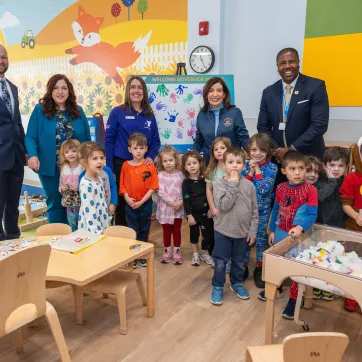Group posing for photo in Irene Skalny Childcare Center