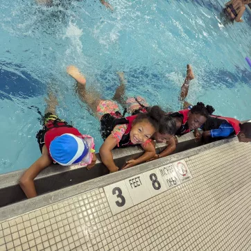 5 children swim together during the Summer LEAP program at the Maplewood Family YMCA