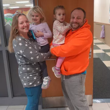 the alfano family of four poses for a picture at the northwest family ymca