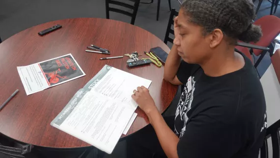 Tamara Schove, Wellness Coordinator at the Maplewood Family YMCA, reads through the Grief Share workbook during a grieving group session at the branch.