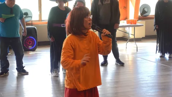 YMCA member signing at the Adult Halloween Party