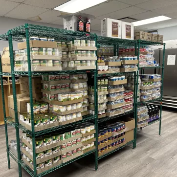 shelves stocked with canned goods at the Lewis Street YMCA Neighborhood Center food pantry opened in partnership with Foodlink