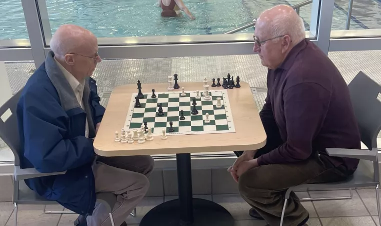two men playing chess at the westside family ymca