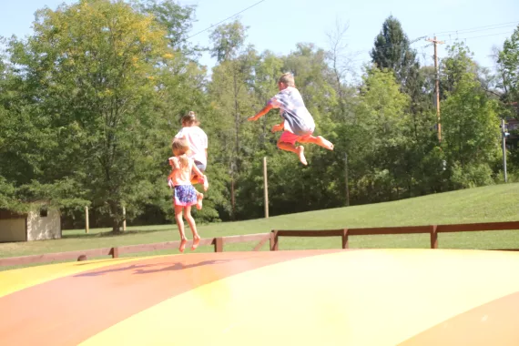 kids jumping on a bounce pillow