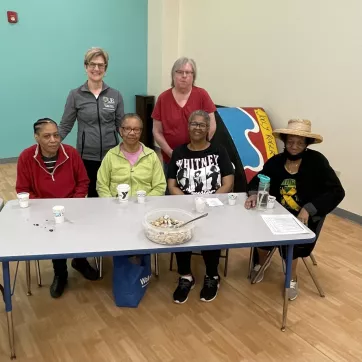 Karen Blank stops for picture with members of the Maplewood Family YMCA during a health talk in partnership with URMC and the YMCA