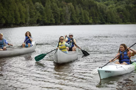 a group of campers in kayaks on Darts Lake at Camp Gorham