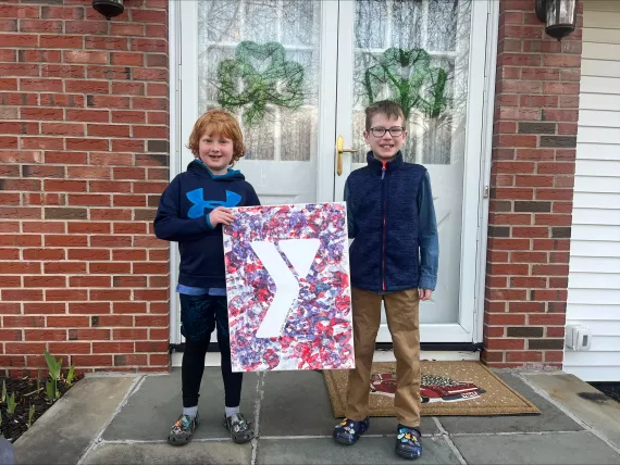 East Rochester BASP children hold up the giant Y project they created in 2023.
