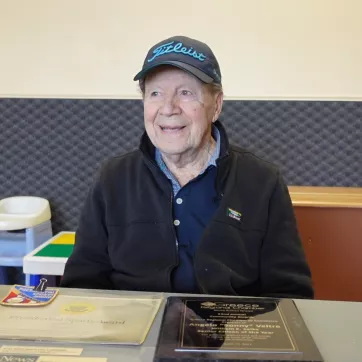 an older man sitting at a table